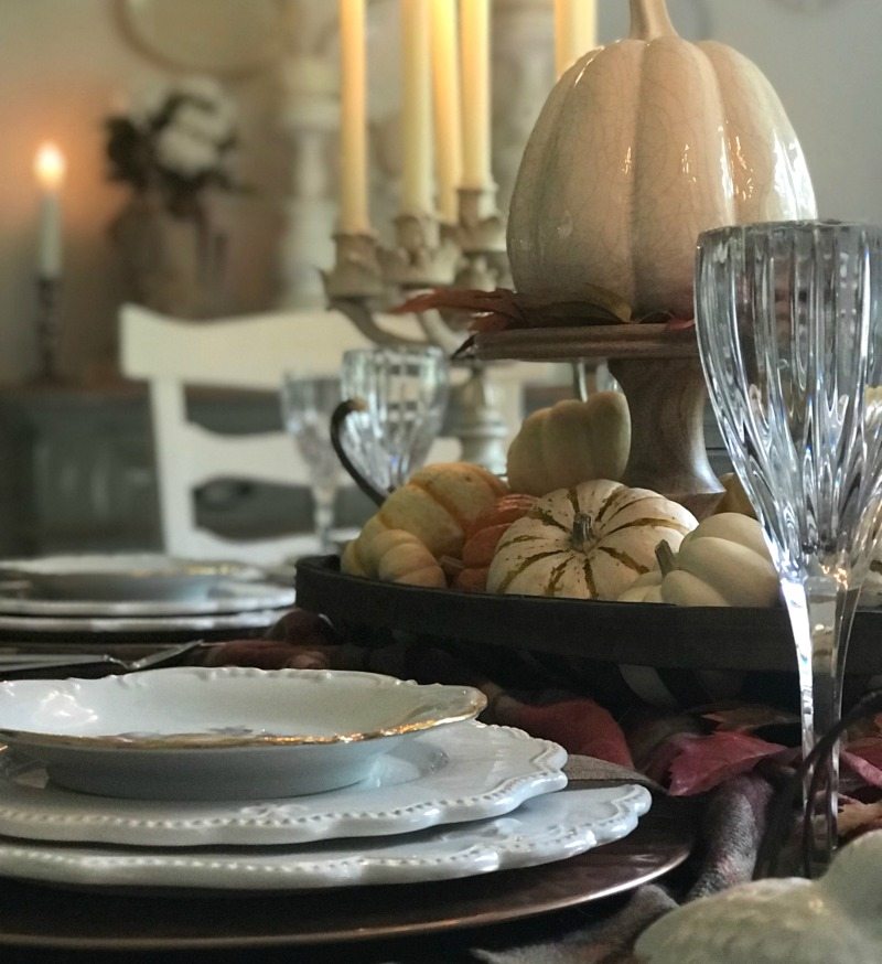 elegant thanksgiving table with white chargers and champagne glasses