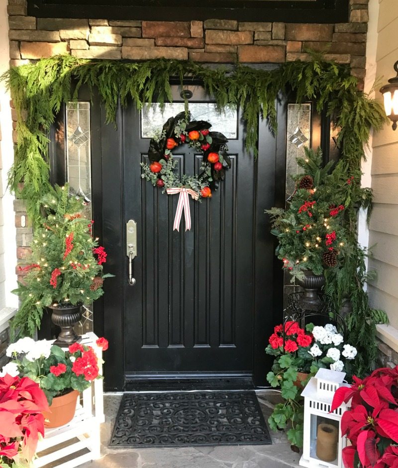 Holiday House Tour front porch with pine garlands and poinsettas