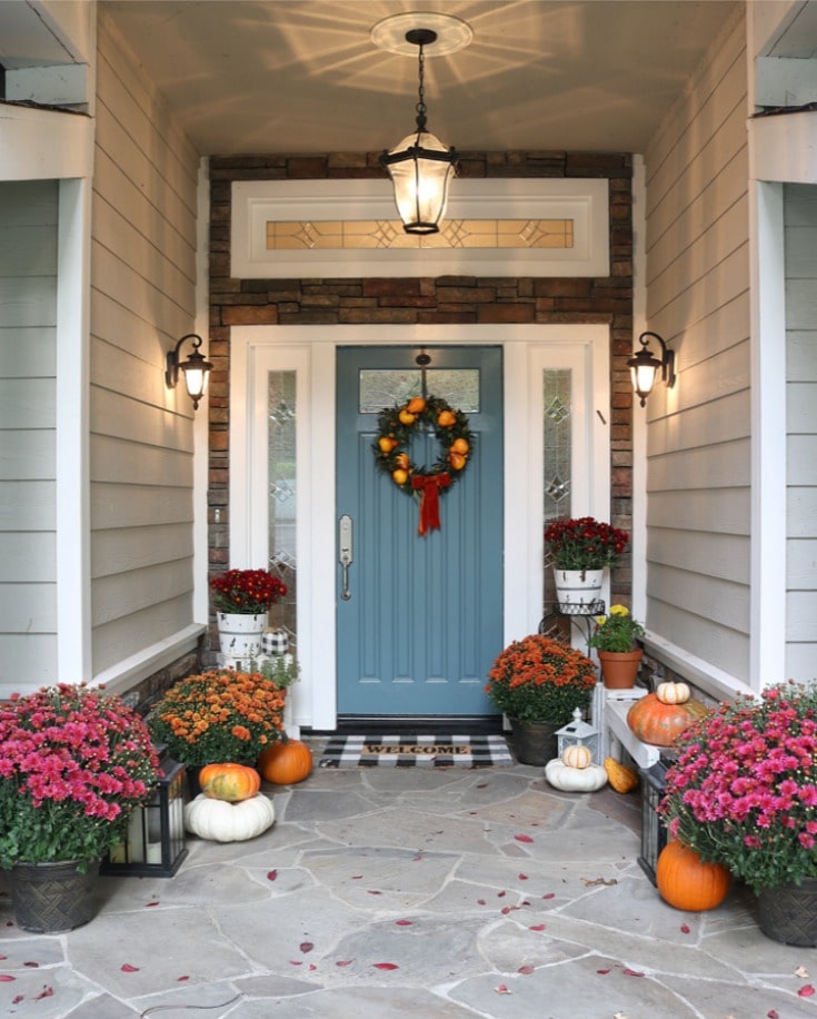 create a beautiful fall front porch with pumpkins, blue front door and mums