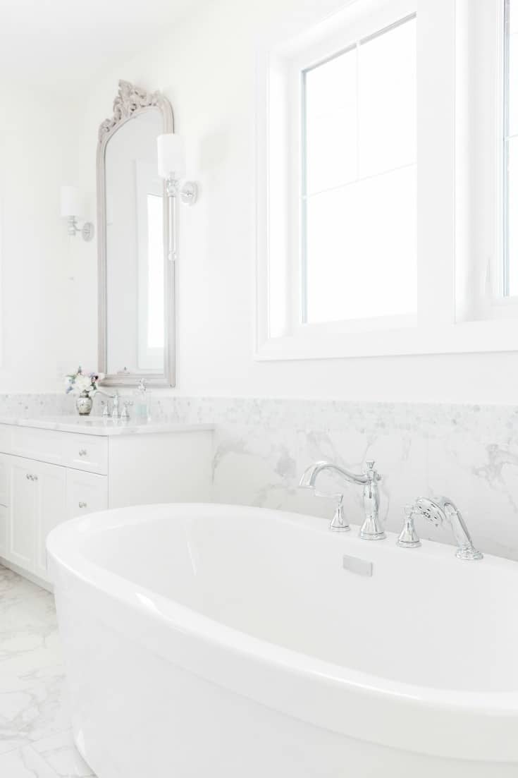 clean white bathroom with clawfoot tub spa
