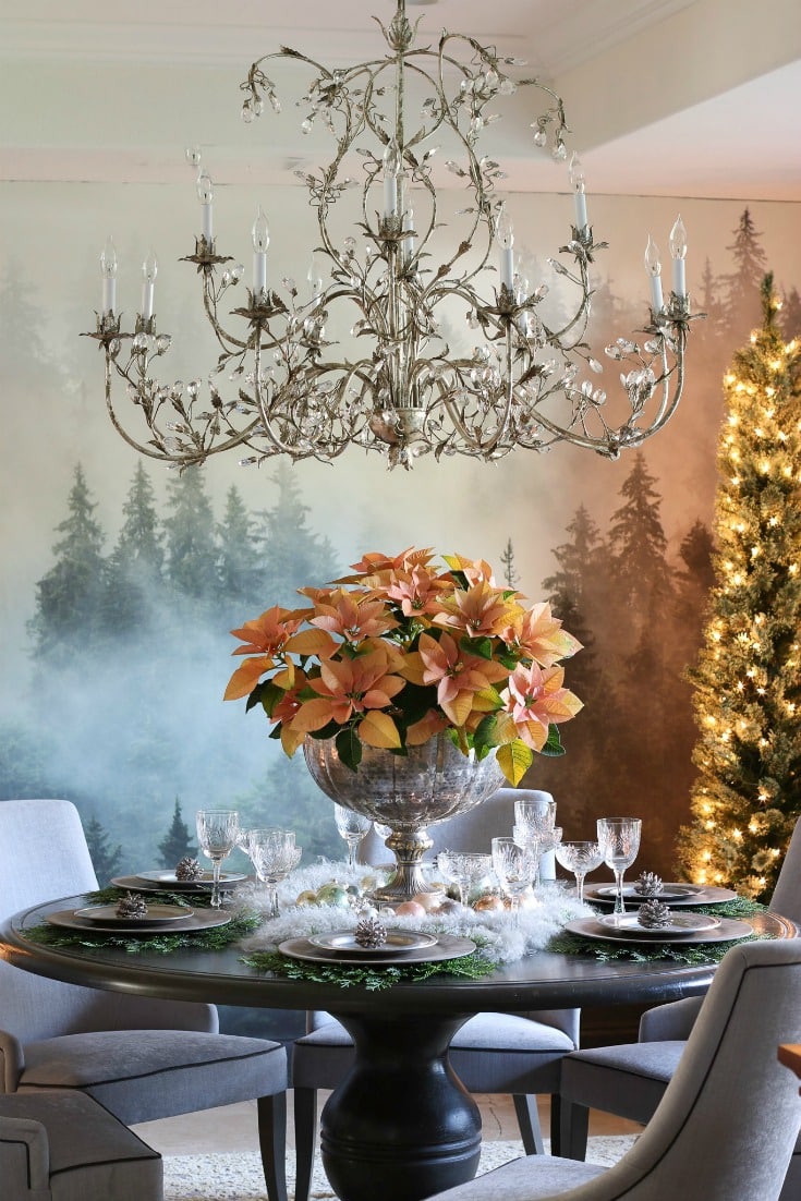 gorgeous dining room with forest mural pink poinsettia centerpiece crystal chandelier and grey upholstered chairs