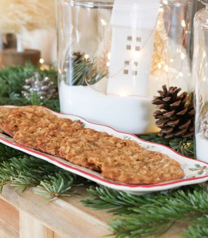 Coconut oatmeal lace cookies layered in a single row on long serving dish
