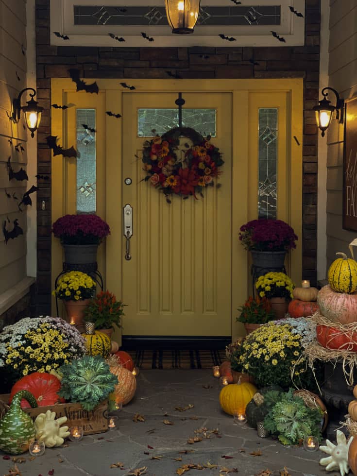 spooky nighttime view of halloween bat decorations at front door