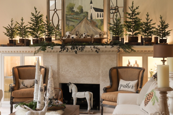 natural trees and neutral Christmas mantel decor with farmhouse painting