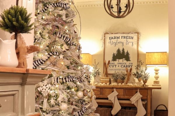 white Christmas tree decorated with black and white ribbons and bows adorns front foyer
