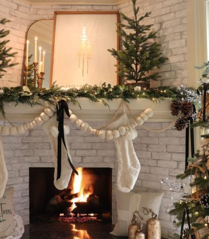 Elegant gold black and white pompom and evergreen Christmas mantel decor