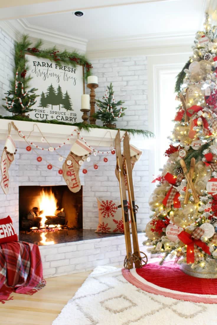 fireplace and mantel and Christmas tree decorated with red and white and mini trees
