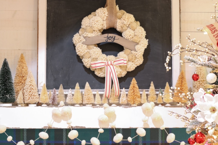 Christmas Fireplace and mantel decorated with pompom wreath and garland