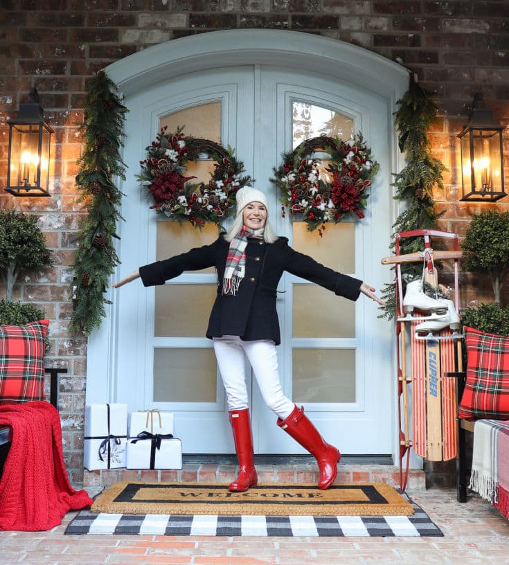 Welcome friends with a festive front door decorated with plaid pops of red and a vintage sled.