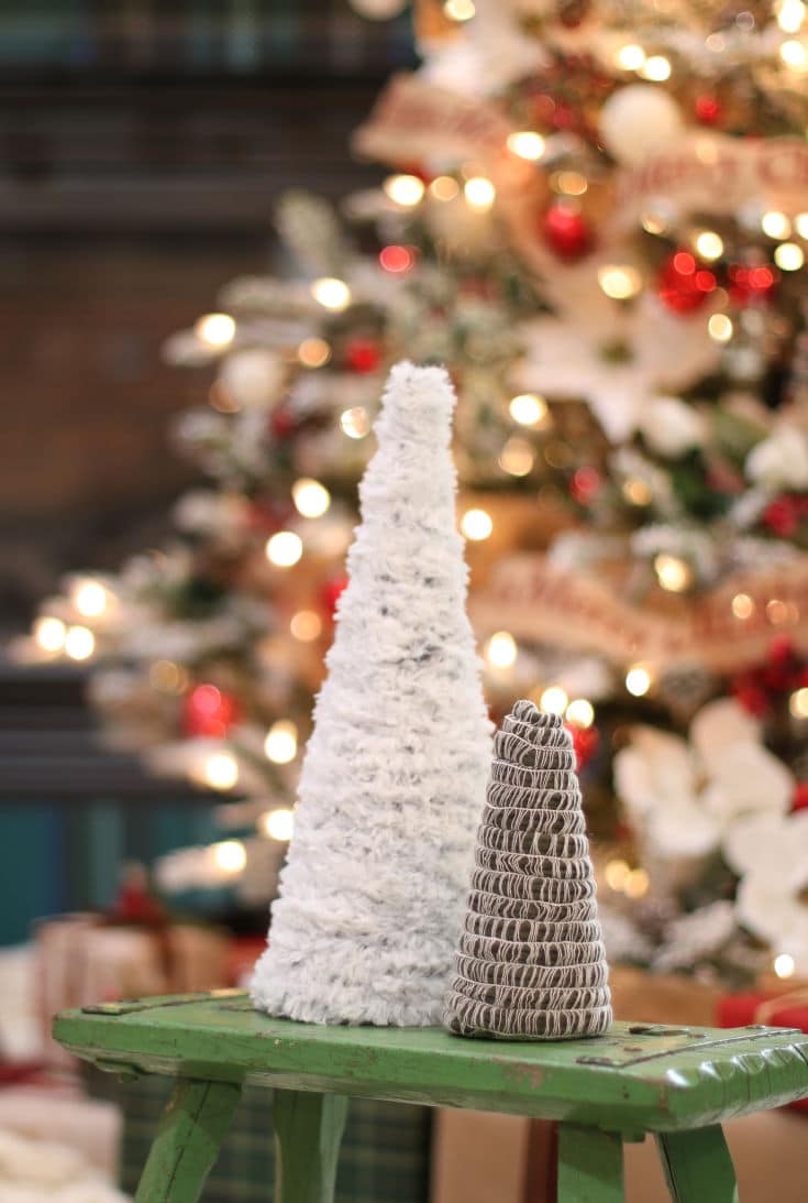 mini Christmas trees made from paper mache cones and different types of yarn