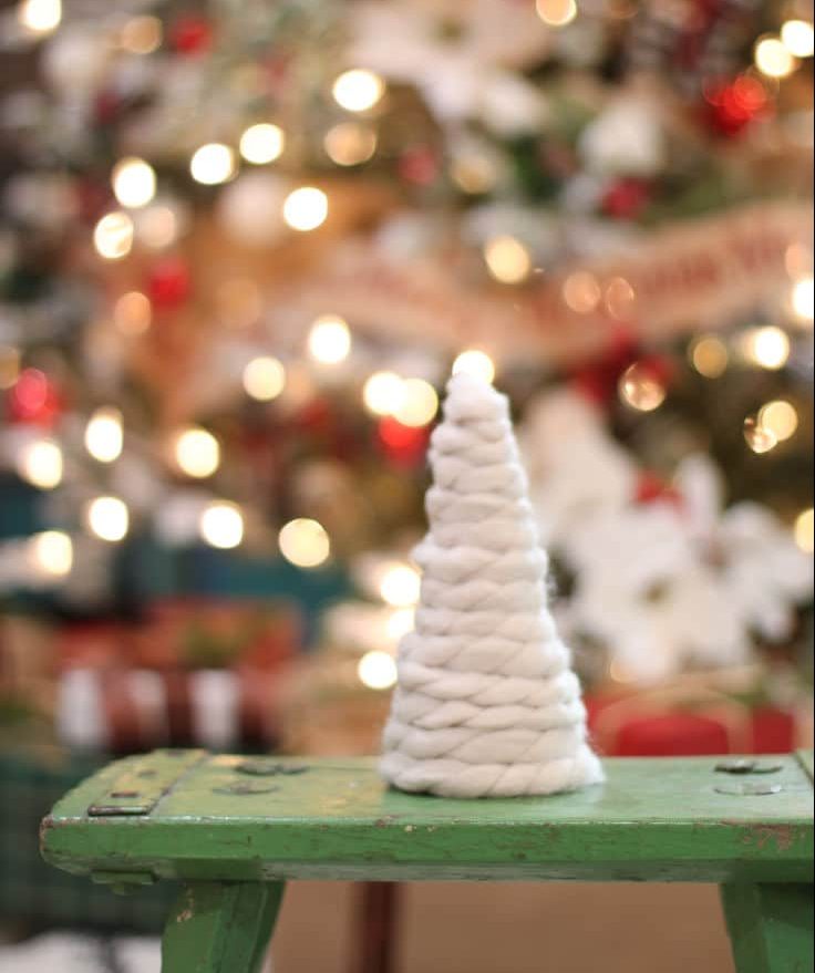 thick yarn makes a perfect mini tree placed in front of Christmas tree