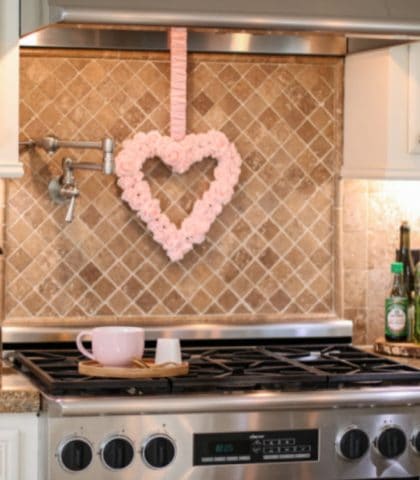 kitchen stainless steel stove with pink valentines day heart wreath hanging