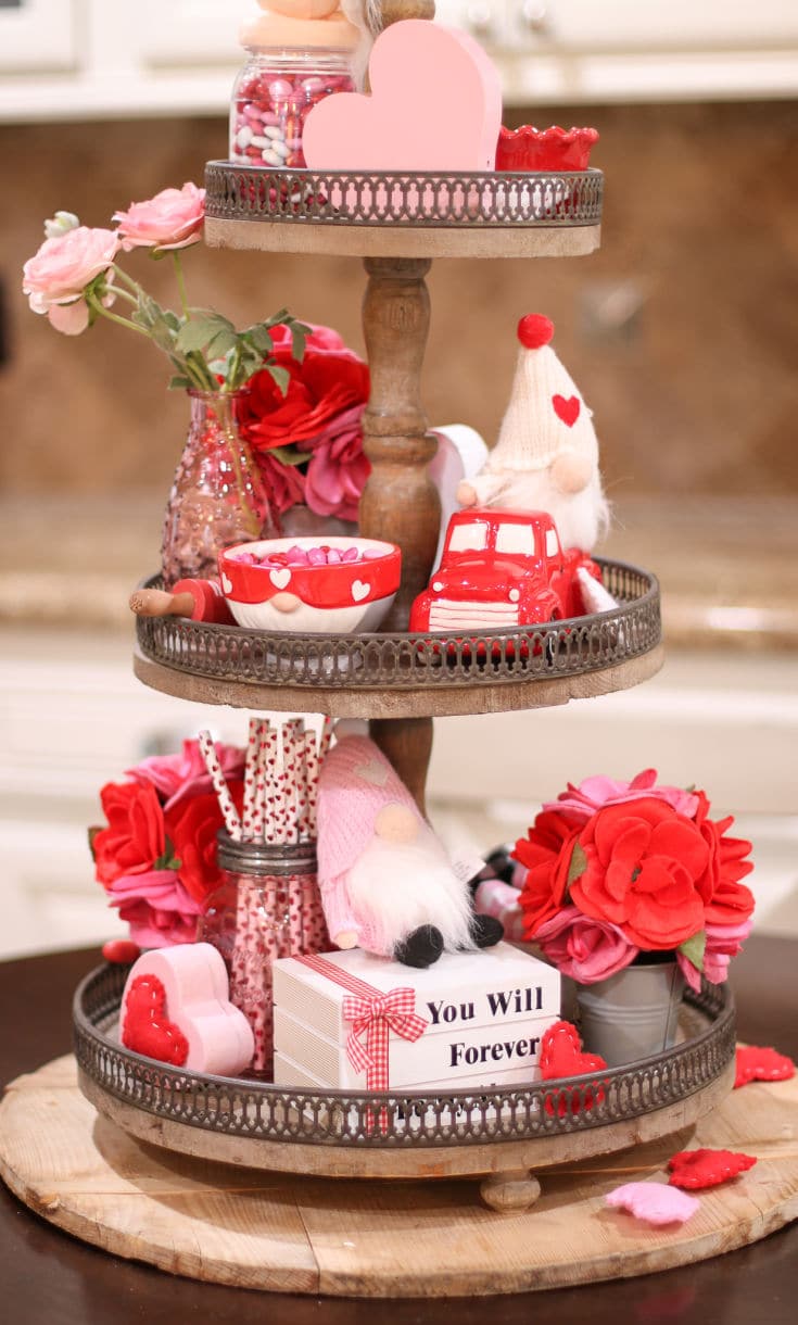 festive valentines tiered tray with lots of red and pink decor