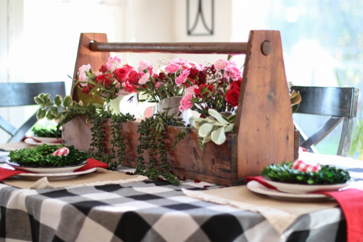 red roses and carnations in vintage tool box make fabulous table display