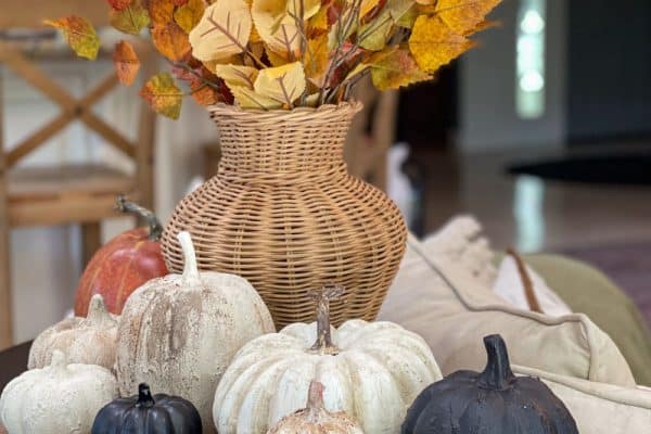 beautiful faux stone pumpkins in different neutral colors add color and texture to this vignette