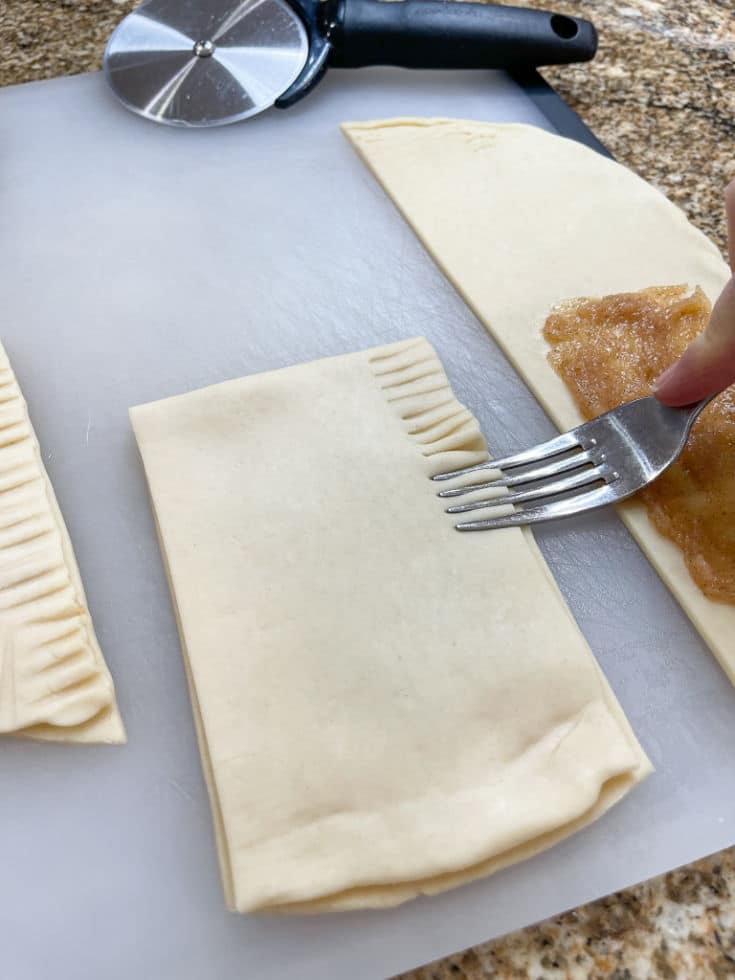 pressing edges of refrigerator pie crust pop tarts with fork